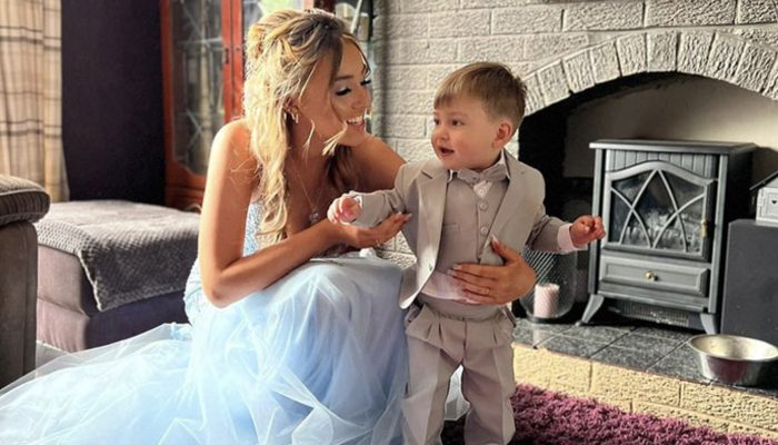 A 16-year-old mum could never have looked more joyful to accept her baby as her date to her school prom.
