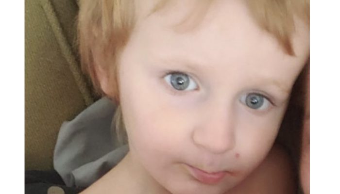 The baby boy with Autism found safely cared for by family dogs. His face is so cute.