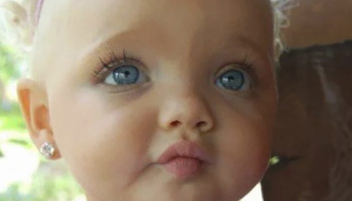 What is the current appearance of the girl who was thought to be a doll when she was younger?