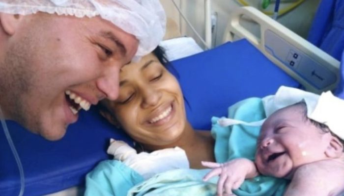 The newborn greeted her father with a big smile and recognized his voice as soon as she entered the world.