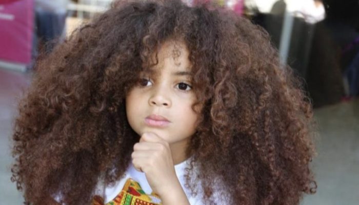 The boy's beautiful hair helped him become a famous when his parents stopped cutting it.