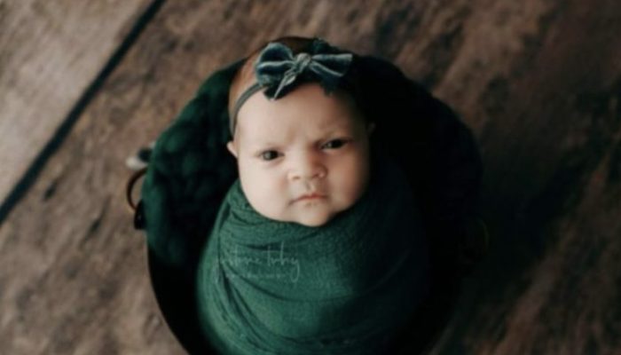 A 14-day-old girl's talking eyes and facial expressions are used to express her unhappiness.