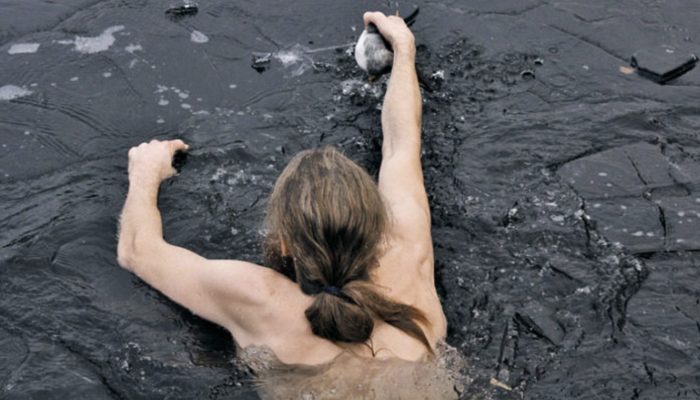 The day's hero. The man jumps into a freezing lake to save a drowning duck.