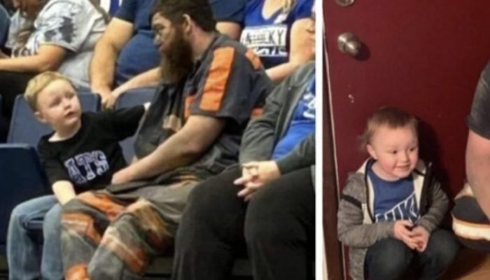 Miner brought his son to the game directly after work. He didn't even have time to change his clothes.