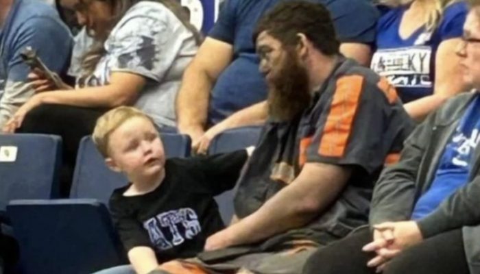 Miner brought his son to the game directly after work. He didn't even have time to change his clothes.