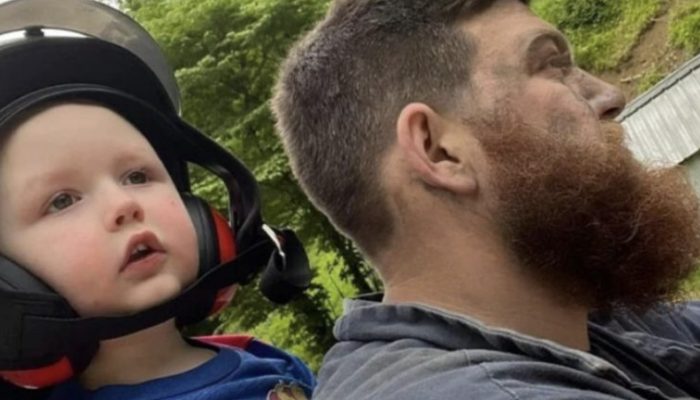 Miner brought his son to the game directly after work. He didn't even have time to change his clothes.