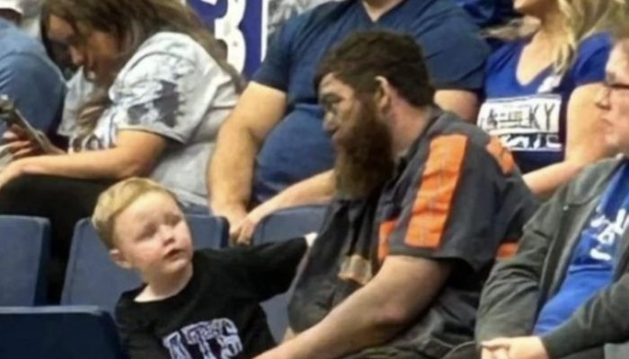 Miner brought his son to the game directly after work. He didn't even have time to change his clothes.