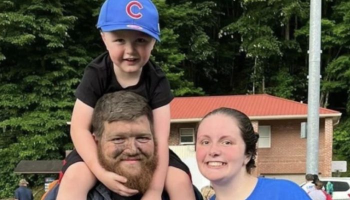 Miner brought his son to the game directly after work. He didn't even have time to change his clothes.